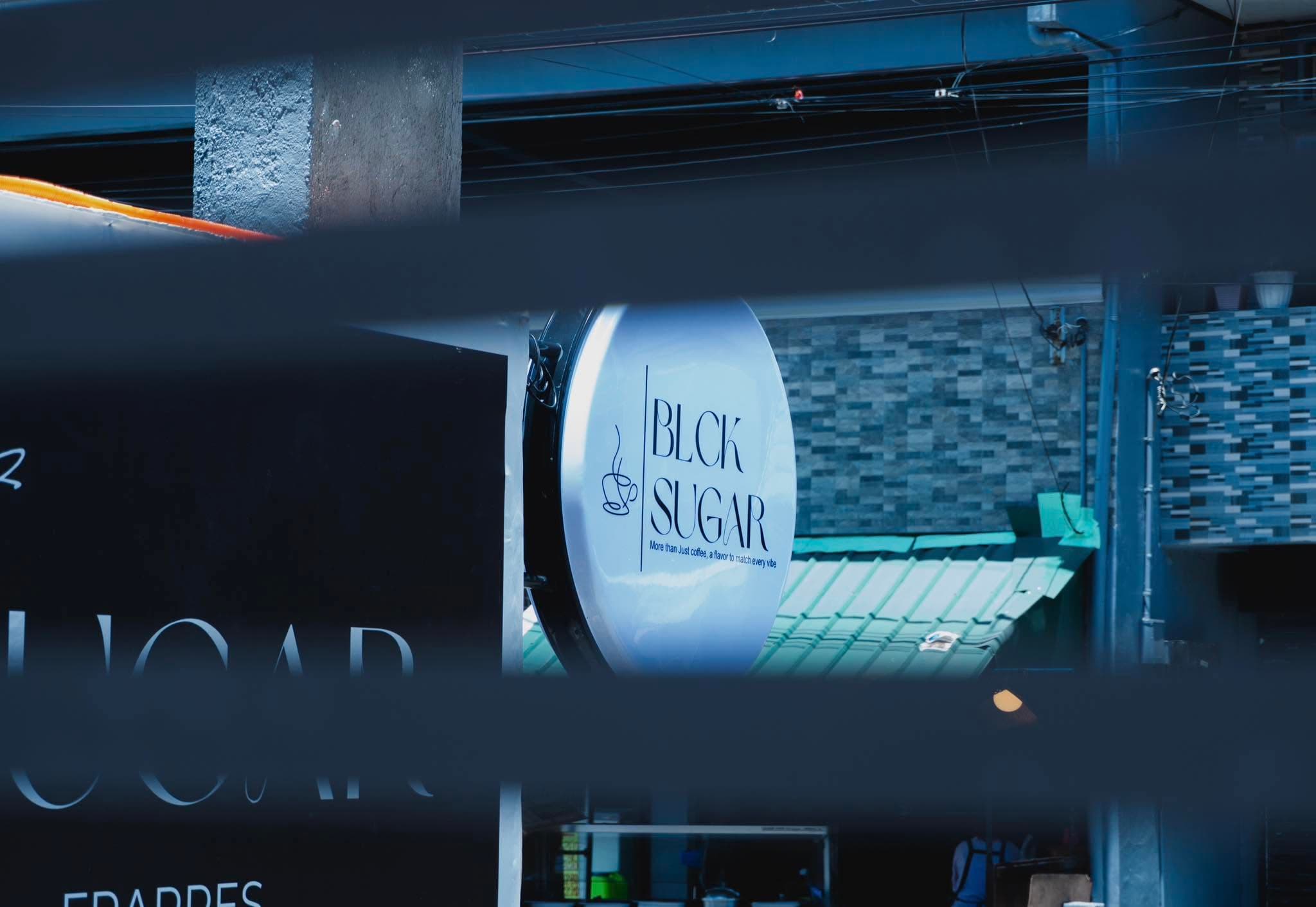BLCK SUGAR cafe sign at night